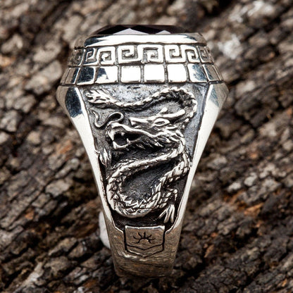 A side view of the men's silver ring showing the detailed carving of an Eastern dragon.