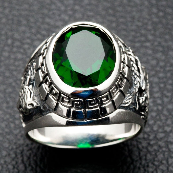 A men's dragon and tiger ring, handcrafted from sterling silver with a large faceted green emerald stone.