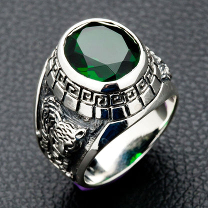 A sterling silver signet ring with a large green emerald CZ, flanked by carvings of a dragon and tiger.