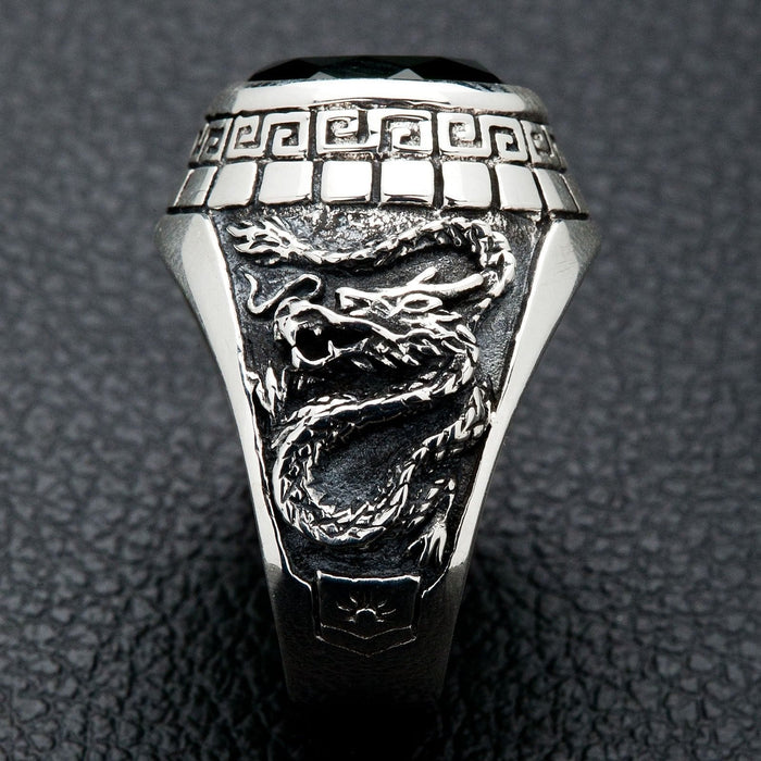 A side view of the men's silver ring showing the detailed carving of an Eastern dragon.