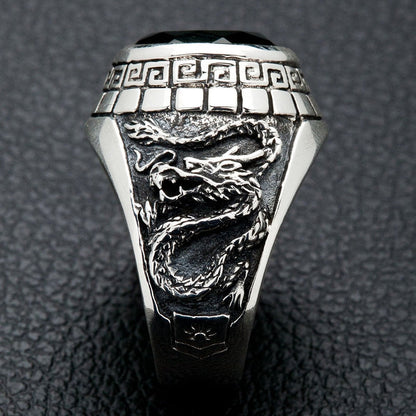A side view of the men's silver ring showing the detailed carving of an Eastern dragon.