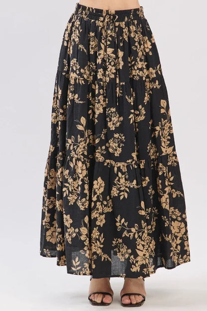 Black drawstring tiered midi skirt with gold botanical print and tiered hem in lightweight fabric
