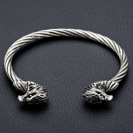 A front view of the men's cuff bracelet, showing the two sterling silver eagle heads and the twisted steel band.