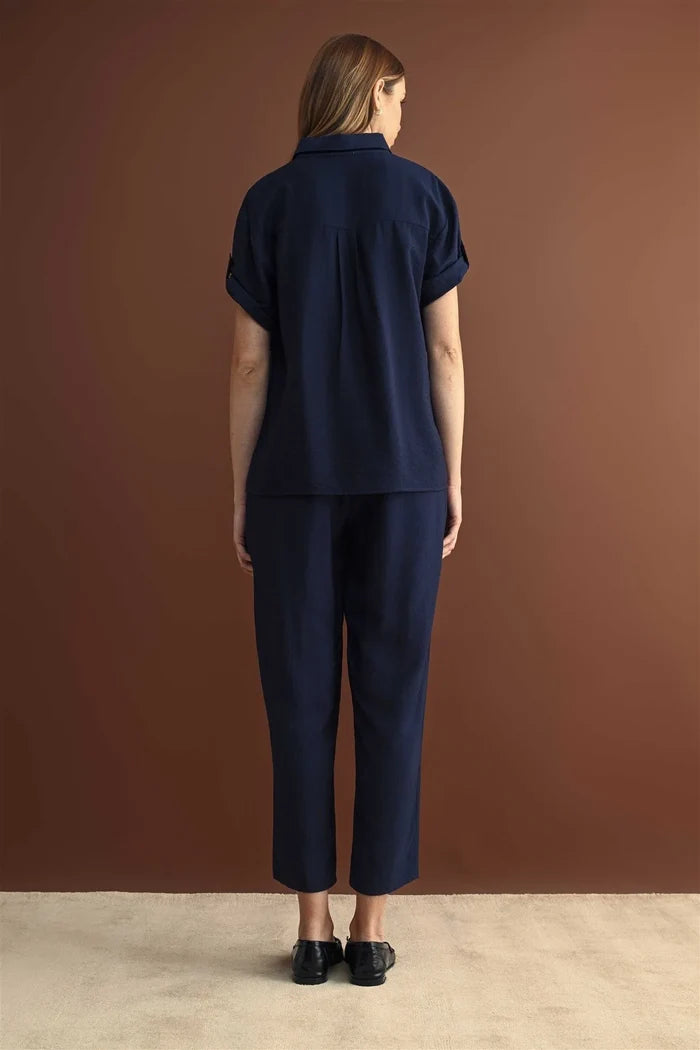 Navy blue short-sleeved collared shirt paired with elastic waist crop navy blue waist crop pants with rolled cuffs