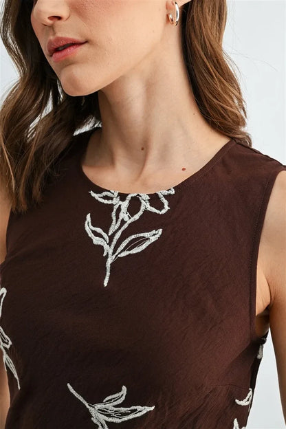 Brown embroidery sleeveless midi dress with white embroidered floral details on sleeveless midi dress fabric