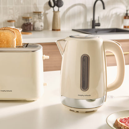 Beige kettle and toaster on a kitchen counter with a blurred background