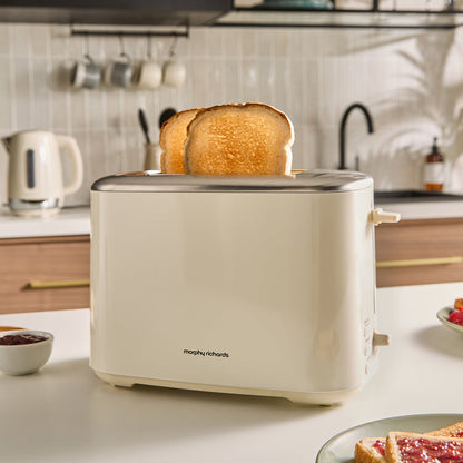 Beige toaster with slices of toast on a kitchen counter