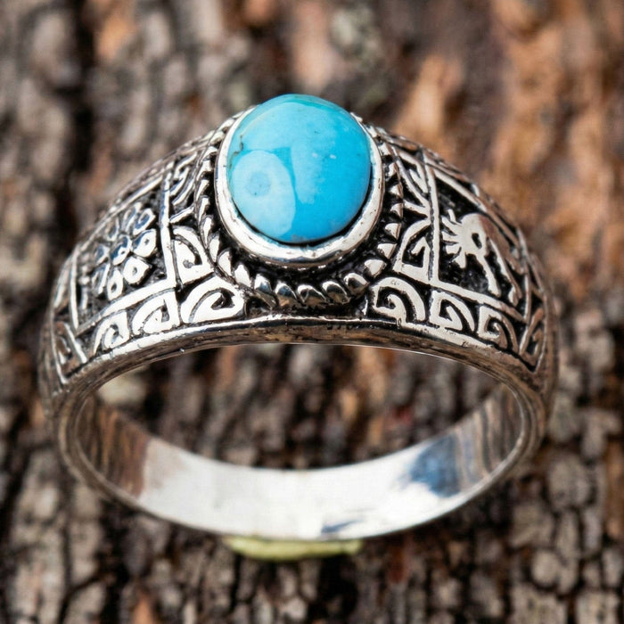 Front view of the ring focusing on the vibrant blue genuine turquoise cabochon stone.
