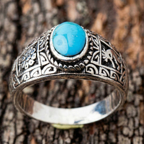 Front view of the ring focusing on the vibrant blue genuine turquoise cabochon stone.