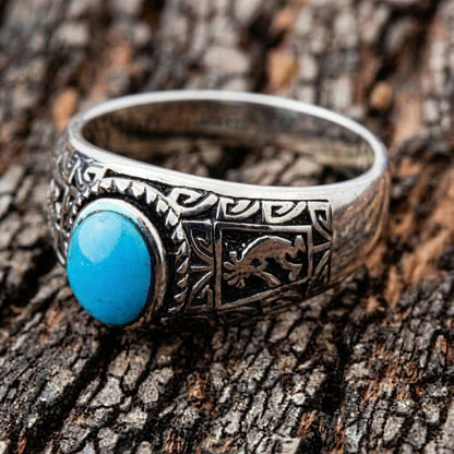 Angled view of the ethnic style ring showing the setting of the stone and the side patterns.