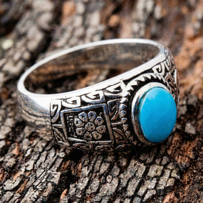 Side view of the sterling silver ring showing the intricate floral ethnic patterns and oxidized finish.