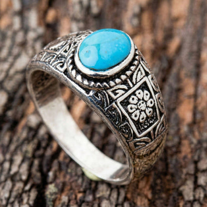 Side view of the ring highlighting the oxidized tribal flower pattern and textured silver finish.