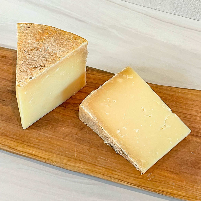 FLORY'S TRUCKLE cheese wedge from Homestead Creamery, Missouri, made with raw cow's milk, firm texture.