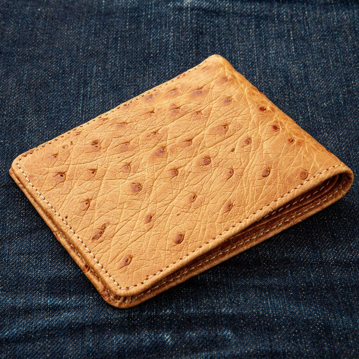 A close-up angled shot of the ostrich skin wallet, highlighting the quill bumps.