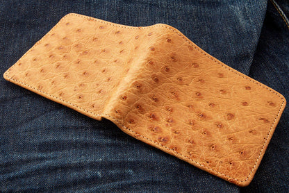 The full exterior of the ostrich wallet laid flat, showing the unique quill bump texture.