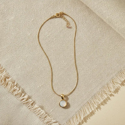 Gold snake chain necklace with a delicate gold snake chain and round white mother of pearl pendant