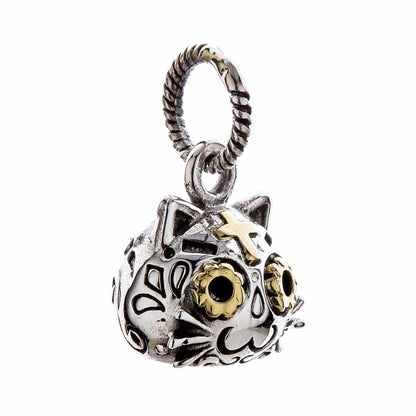 Angled shot of cat pendant emphasizing detailed engravings and golden eye accents.