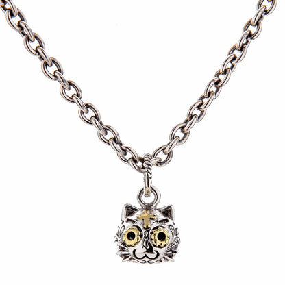 The gothic cat pendant shown hanging from a sterling silver necklace.