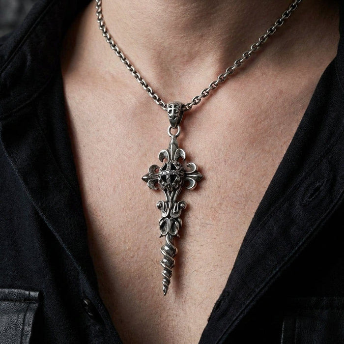 Lifestyle view of a man wearing the silver fleur-de-lis and twisted dagger pendant over a black shirt.
