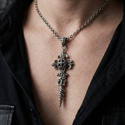 Lifestyle view of a man wearing the silver fleur-de-lis and twisted dagger pendant over a black shirt.