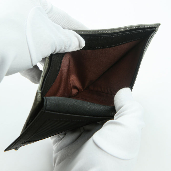 Bill compartment showing brown satin lining inside grey ostrich wallet