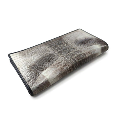 Tail crocodile skin wallet at three-quarter angle, revealing dimensional scale texture and black leather trim.
