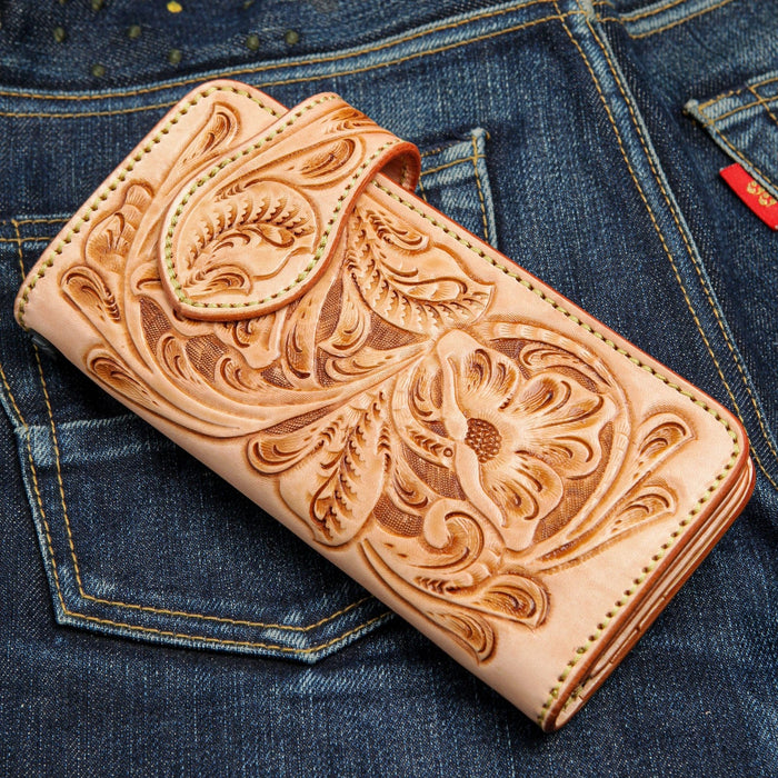 The natural leather long biker wallet shown closed, highlighting the hand-tooled floral pattern.
