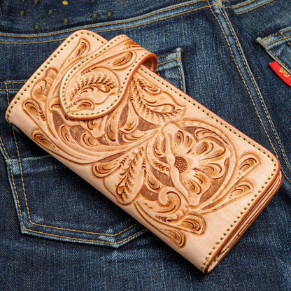 The natural leather long biker wallet shown closed, highlighting the hand-tooled floral pattern.