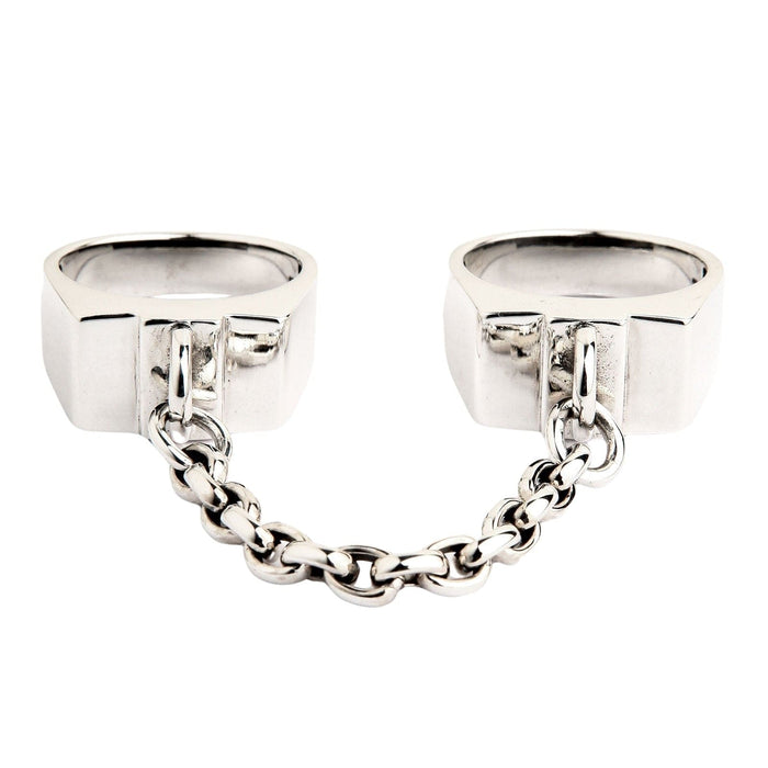 A front view of the sterling silver handcuff rings connected by a chain, isolated on a white background.
