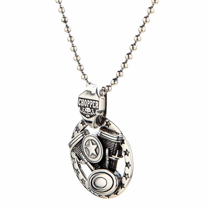 Three-quarter perspective of the silver motorcycle necklace, showing the thick CHOPPER bail and layered V-twin engine.