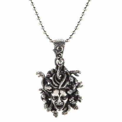 Full length shot of the oxidized gorgon pendant hanging perfectly straight on a silver ball chain