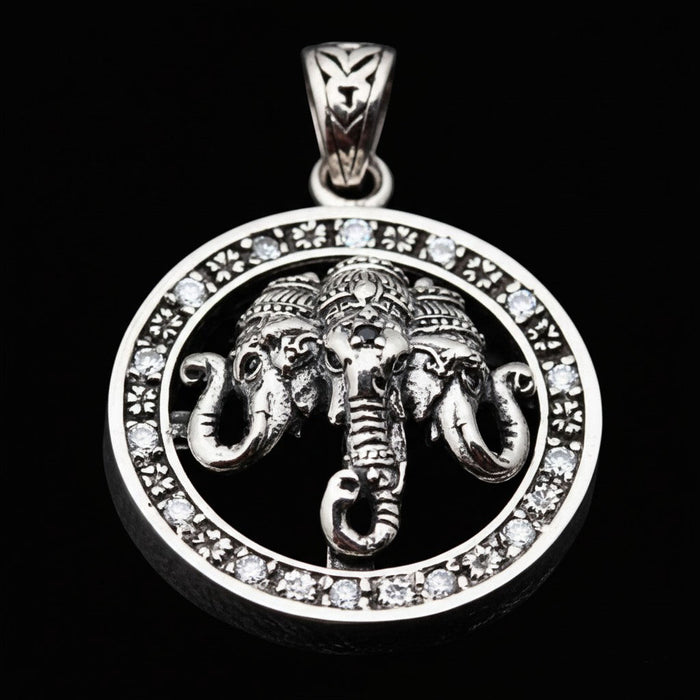 Angled view of the three-headed Airavata elephant pendant in sterling silver with clear stones on a black background.