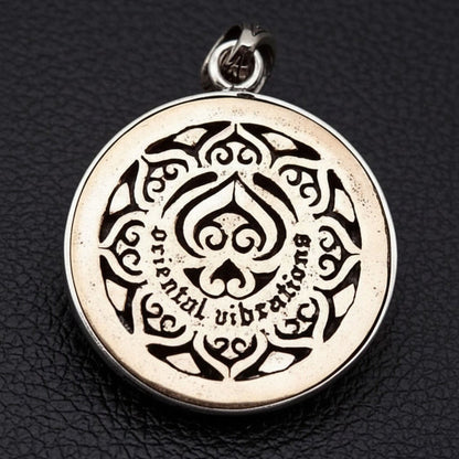 The back of the Ganesha elephant pendant showing the two-tone brass plate engraved with "Oriental vibrations".