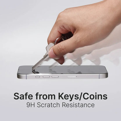 A hand scrapes a key across an iPhone 16e/14/13 with the Catalyst Case US Tempered Glass Screen Protector, showing its 9H scratch resistance. The screen stays flawless—offering durable protection against keys or coins.