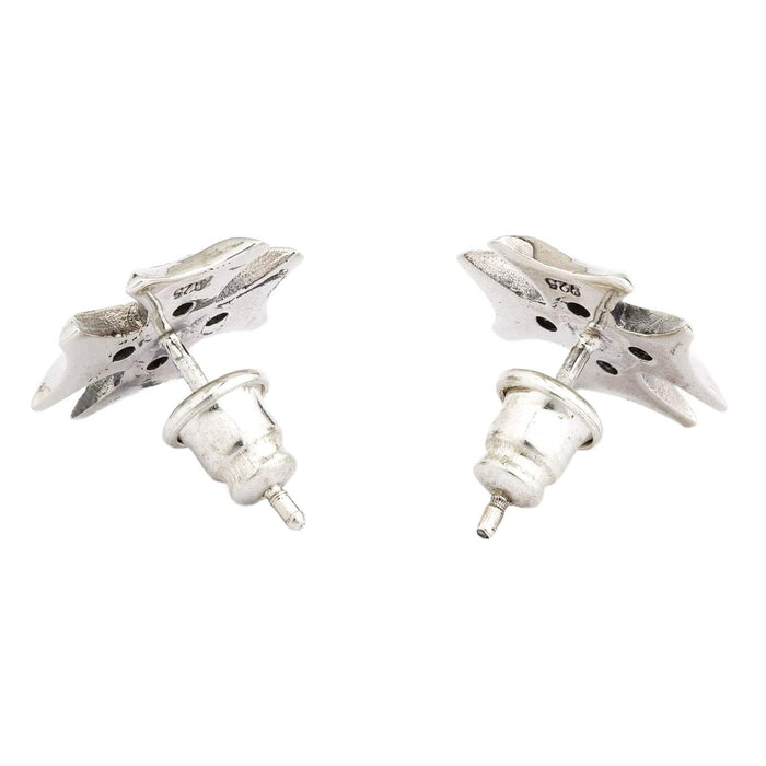 The back view of a pair of sterling silver Iron Cross stud earrings, clearly showing the 925 hallmark stamp for authenticity.