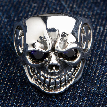 Front view of the solid 925 sterling silver iron cross skull ring with sparkling blue eyes.