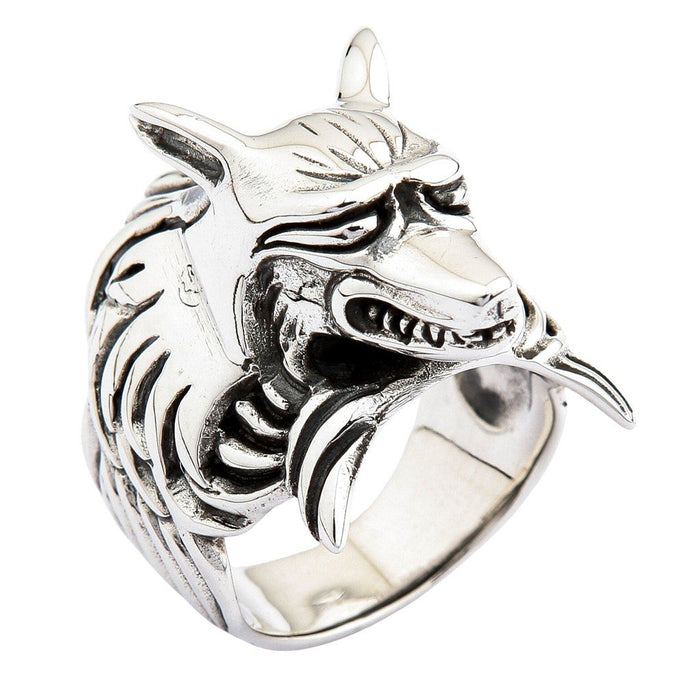 Three-quarter profile of massive sterling silver kitsune ring showing bared fangs, furrowed brow, and flowing mane texture