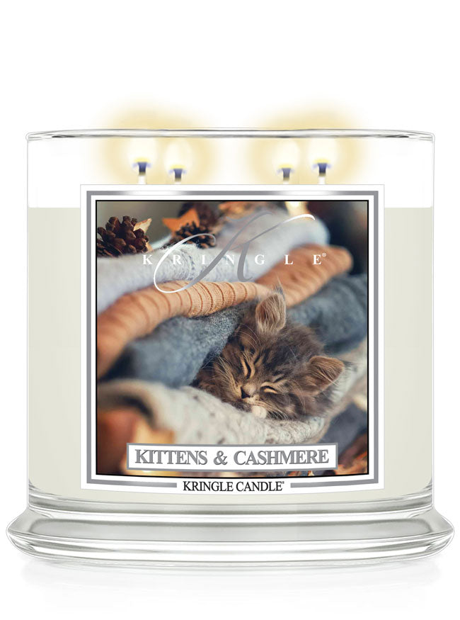 Kringle Candle with a kitten and cashmere 4-wick lit candle with a kitten label on a white background