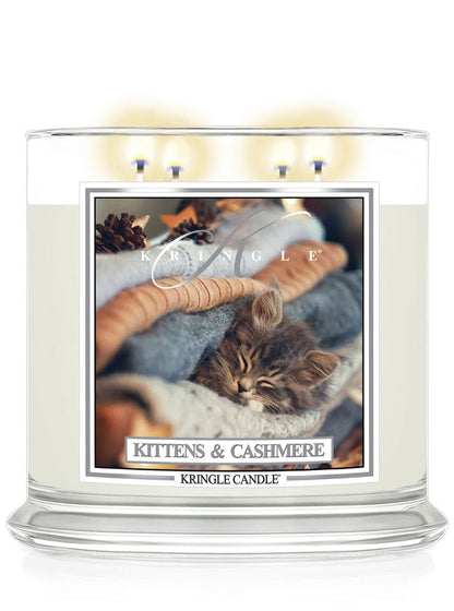 Kringle Candle with a kitten and cashmere 4-wick lit candle with a kitten label on a white background