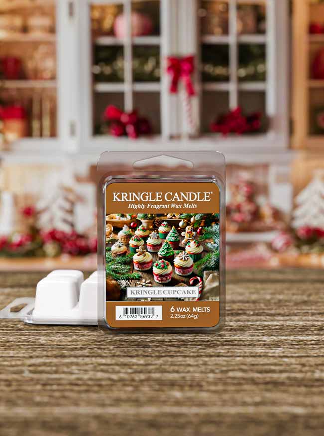 Kringle Candle wax melts packaging on a wooden surface with a festive background