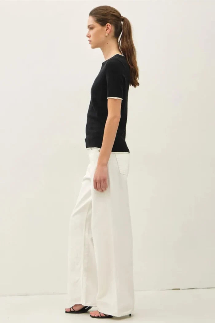 Black essential short sleeve sweater top with white trim at neckline and sleeve hems for layered look essentials