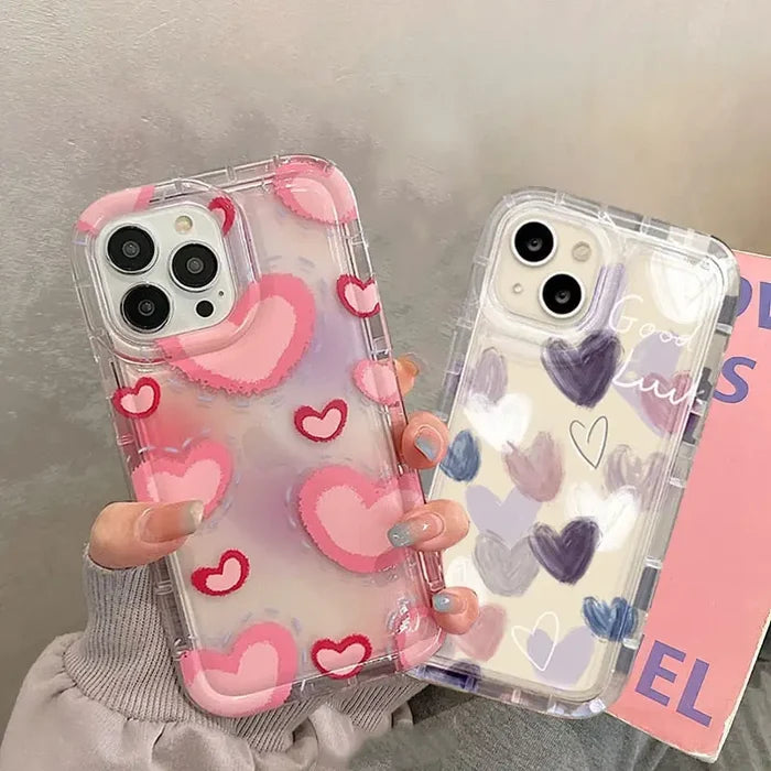 a woman holding a phone case with hearts on it