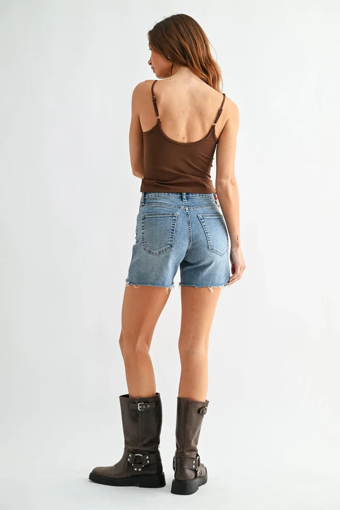 Back view of brown spaghetti strap top with cutout on low rise walking denim short