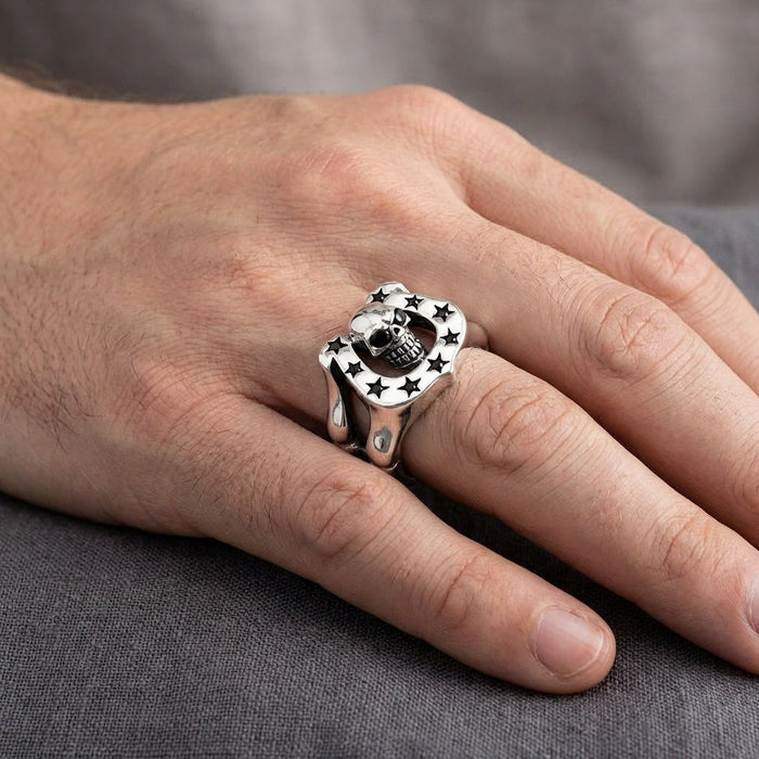 Skull and horseshoe silver ring worn on middle finger showing comfortable fit and ring proportion on hand