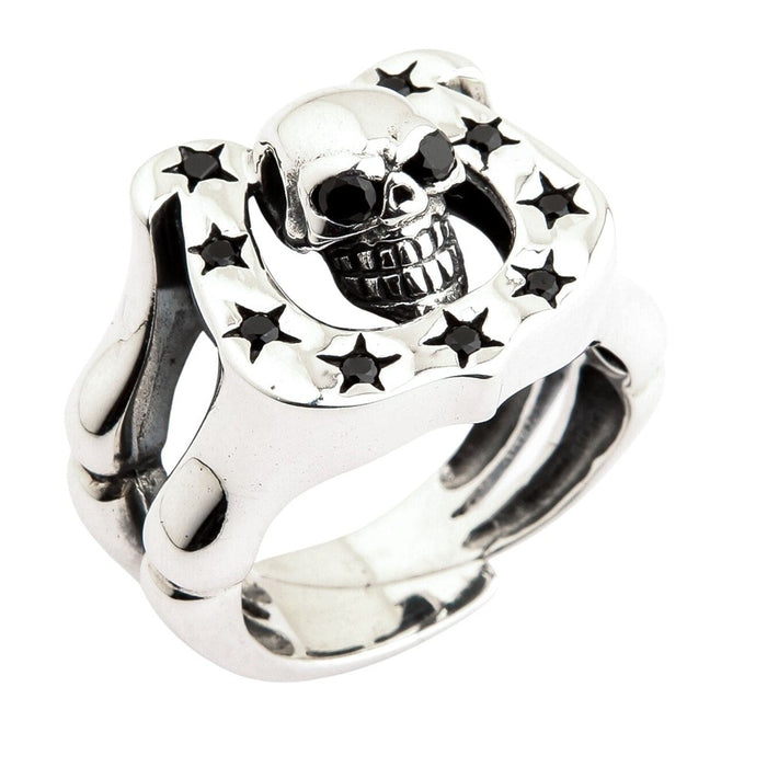 Detailed angle of biker style skull ring with horseshoe frame and star shaped black stone accents in sterling silver