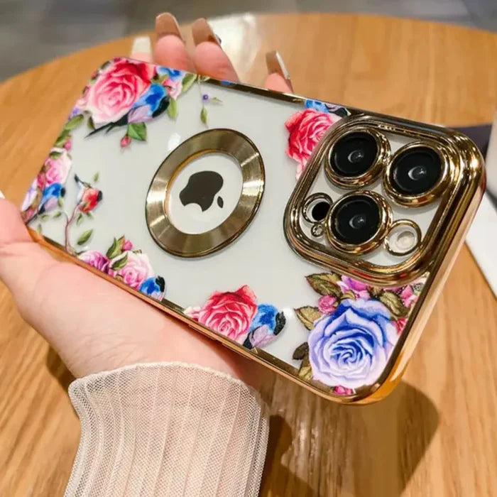 a woman holding a phone case with flowers on it