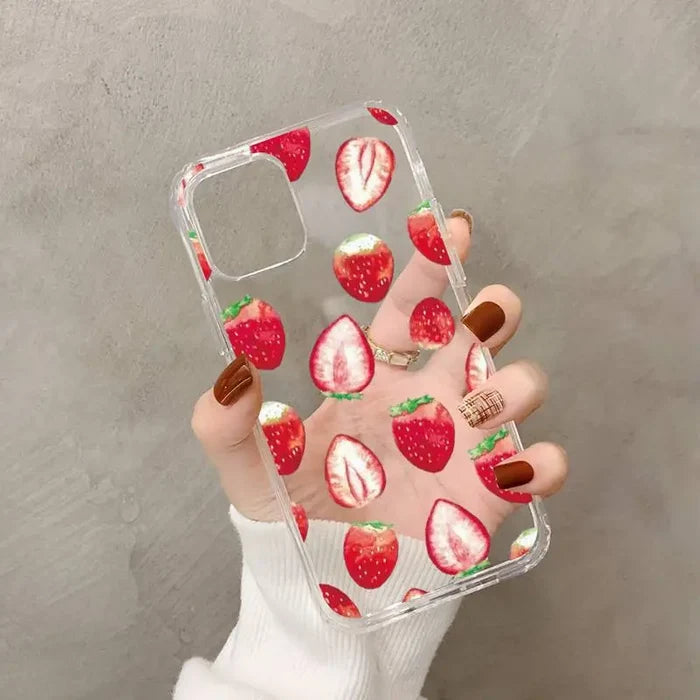 a woman holding a phone case with strawberries on it