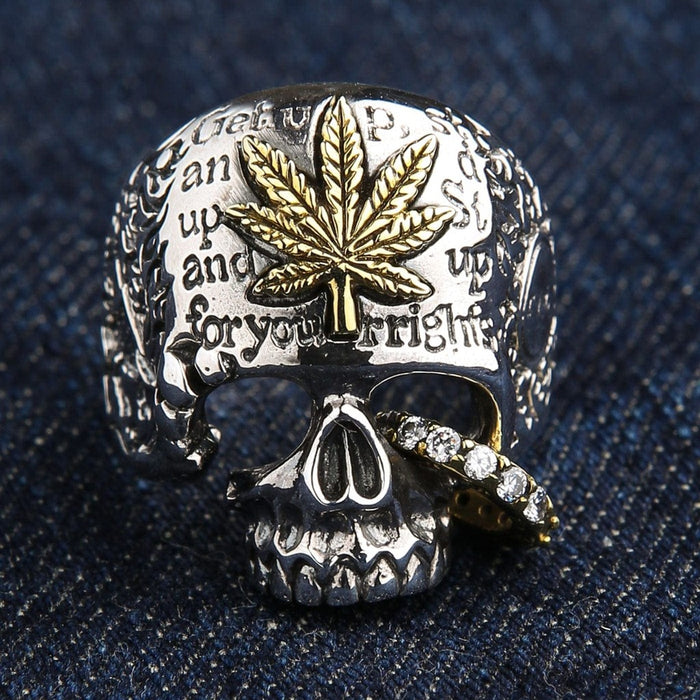 Front view of sterling silver skull ring with brass marijuana leaf and CZ stones