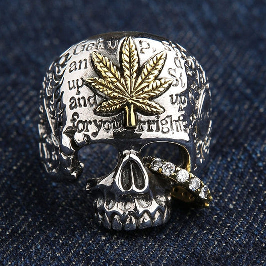 Front view of sterling silver skull ring with brass marijuana leaf and CZ stones