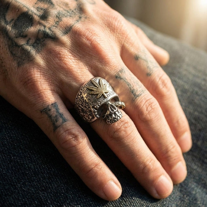 Marijuana leaf skull ring in 925 sterling silver with brass accent worn on tattooed hand
